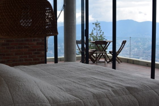 Suite blanca con terraza, mesa bistró y vista 180 grados